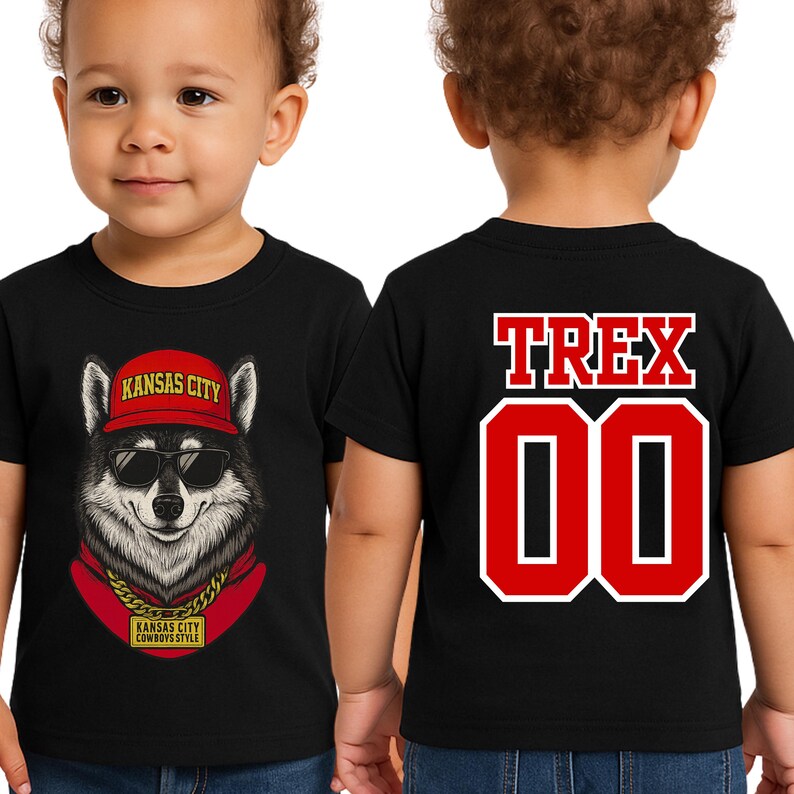 A young child wearing a black t-shirt with a graphic of a wolf wearing sunglasses and a red hat, along with the text "KANSAS CITY" and "COWBOYS STYLE".