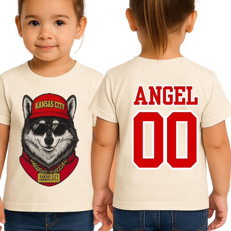 A young girl wearing a white t-shirt with a graphic of a husky dog wearing sunglasses and a red hat, along with the text "KANSAS CITY" and "KANSAS CITY COWBOYS STYLE".