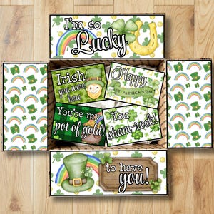 Könnte beinhalten: Eine Geschenkbox zum Thema St. Patrick's Day mit verschiedenen Karten und dekorativen Elementen. Die Karten zeigen Sätze wie „I'm so Lucky“, „Irish you were here“ und „You're my pot of gold!“. Die Box ist mit Regenbogen, Kleeblättern und Leprechaun-Hüten dekoriert.