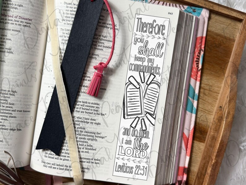 May include: A black bookmark with a pink tassel and a white paper bookmark featuring the black ink text Therefore you shall keep my commandments, and do them. I am the LORD. Leviticus 22:31, alongside an illustration of two stone tablets.