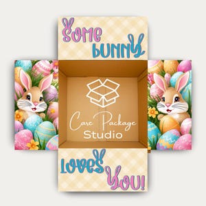 May include: An open cardboard box with Easter-themed decorations. The box features cartoon bunnies, colorful Easter eggs, and the phrases "Some Bunny Loves You!" and "Care Package Studio."
