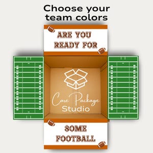 May include: A cardboard box with football-themed decorations. The box is open, revealing a football field design on the inside flaps. Text on the box reads "Choose your team colors," "Are you ready for some football," and "Care Package Studio."
