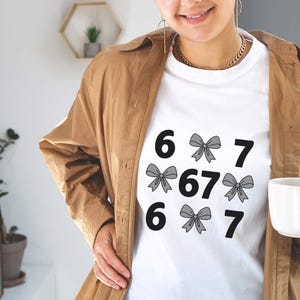 funny shirt,67 hand Png Svg,football,Sports Gift shirt,viral meme shirt,2025 trend,six seven joke67 meme, 67 sweater, Cute 67 png, 67 meme design, Six Seven Png, Six Seven Shirt, Viral Tik Tok Png,Funny Saying Shirt, funny 6 7 design png
Six Seven 6 7 Meme Funny Hands PNG Bundle, Viral Internet Meme Humor, Funny Generation Z, 67 Trend, Funny Social Media,Sports Gift shirt
Funny PNG, Six Seven Png, Six Seven Shirt, 6 7 Shirt, Viral Phrase Meme T-Shirt, Viral TikTok Png, Funny Saying Shirt