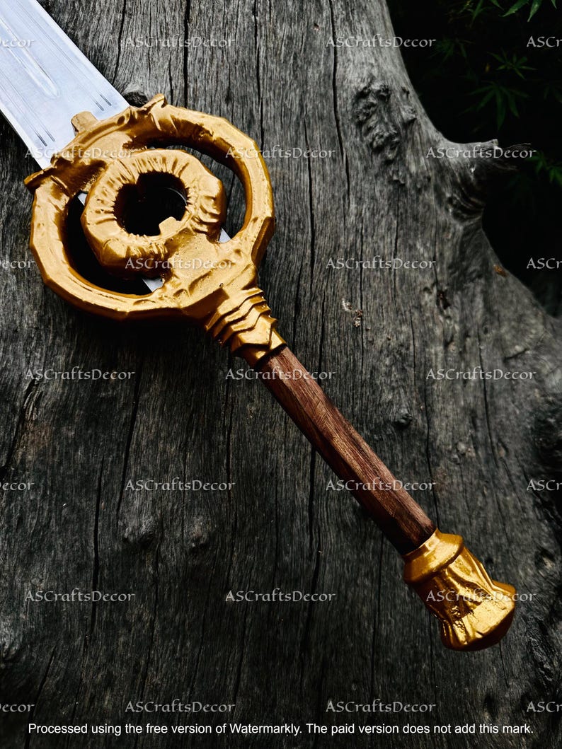 May include: A decorative sword with a gold-coloured key-shaped hilt and a wooden handle. The blade is silver. The hilt features an ornate design with a spiral element. The handle is a dark brown colour, and the pommel is gold.