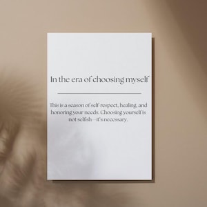May include: A white poster with the text "In the era of choosing myself." The poster also includes the text: "This is a season of self-respect, healing, and honouring your needs. Choosing yourself is not selfish - it's necessary."