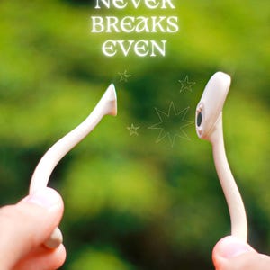 May include: A close-up of a wishbone held between two hands, with the text "WISHBONE NEVER BREAKS EVEN" in white. The background is a blurred green. The wishbone is white and has a curved shape.