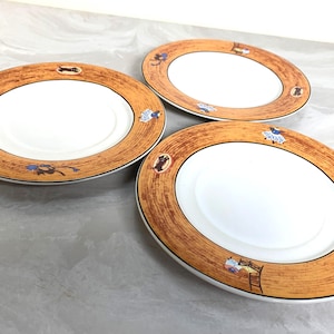 May include: A set of three ceramic mugs with a speckled, matte finish. The mugs are in shades of cream, light gray, and dark gray. Each mug has a simple, minimalist design and a rounded handle.