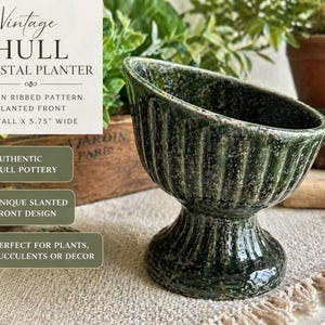 May include: Vintage Hull pedestal planter with a green ribbed pattern and slanted front. The planter is 5 inches tall and 5.75 inches wide. Authentic Hull pottery. Unique slanted front design.