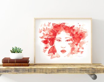 May include: A framed watercolour painting of a woman's face with red butterflies surrounding her head. The painting is on a wooden shelf with a small potted plant and a vase.