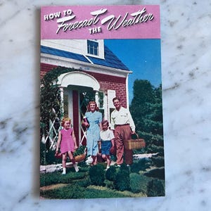 May include: A vintage book cover titled "How to Forecast the Weather." The cover features a family in front of a red brick house with a blue roof. The family is carrying baskets, suggesting a picnic or outdoor activity. The sky is blue.
