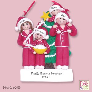 May include: A Christmas ornament featuring a family of four in red pajamas and Santa hats, standing in front of a green Christmas tree. The ornament has the names "Mom", "Dad", "Harper", and "Grayson" on the hats. The base reads "Family Name or Message 2026".