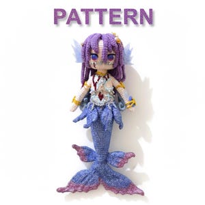 May include: Crocheted mermaid doll with a purple tail and hair, adorned with gold accents and a detailed bodice. The doll has a blue and purple tail fin and is set against a white background. The word "PATTERN" is displayed above the doll.