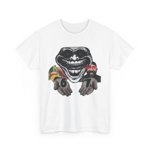 May include: White t-shirt featuring a graphic design. The design includes a black and white troll face, a man with red eyes, and the numbers 6 and 7 on hands. The shirt also has a fruit graphic.