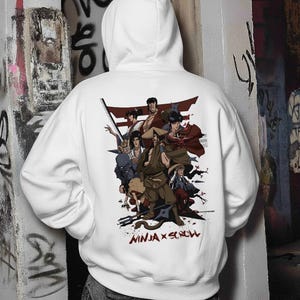 May include: A white hooded sweatshirt featuring a large graphic print on the back. The design displays a group of illustrated ninja characters in various poses, set against a red torii gate. The text "NINJA X SCROLL" is printed in red below.
