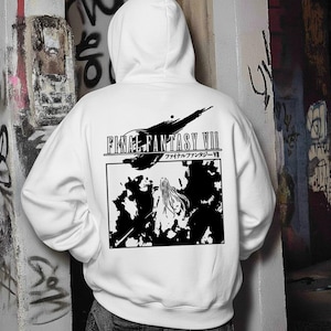May include: White hooded sweatshirt featuring a black and white graphic from Final Fantasy VII. The design includes the game's logo and a stylized illustration. The back of the hoodie displays the game's title in English and Japanese.