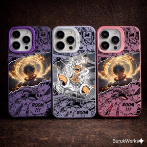 May include: Three phone cases with comic book style art. The cases are purple, silver, and pink. The purple and pink cases feature a character with a fiery aura. The silver case has a character in a white outfit. Each case has the text "ROOM !!!".