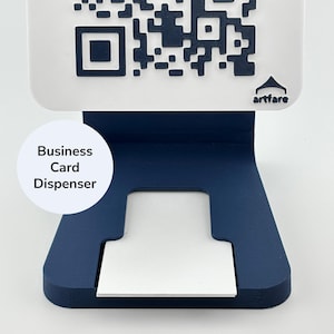 May include: A navy blue business card dispenser with a white base. The dispenser has a QR code on the top and the words "Business Card Dispenser" in a white circle. The brand name "artfare" is also visible.