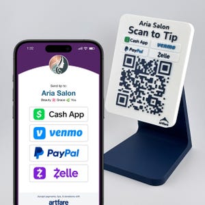 May include: A smartphone displaying a digital payment interface for Aria Salon alongside a white rectangular sign on a dark blue stand. The sign features the text Aria Salon Scan to Tip, logos for Cash App, Venmo, PayPal, and Zelle, and a QR code.
