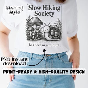 May include: White t-shirt featuring a black and white illustration of a snail with a backpack and mushrooms, with the text "Slow Hiking Society" and "be there in a minute". The shirt also has the text "PNG Instant download" and "PRINT-READY & HIGH-QUALITY DESIGN".