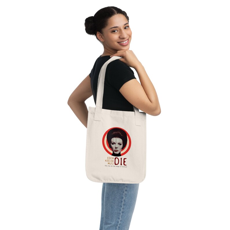 May include: A white tote bag with a red circle and a woman's face in the center. The text on the bag reads "Edith Keeler Must Die" and "The city on the edge of forever".