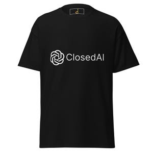 May include: A black short-sleeved t-shirt featuring a white graphic on the chest. The graphic consists of a stylized geometric knot icon next to the text ClosedAI in a clean sans-serif font. A small gold letter d is visible on the inner neck label.