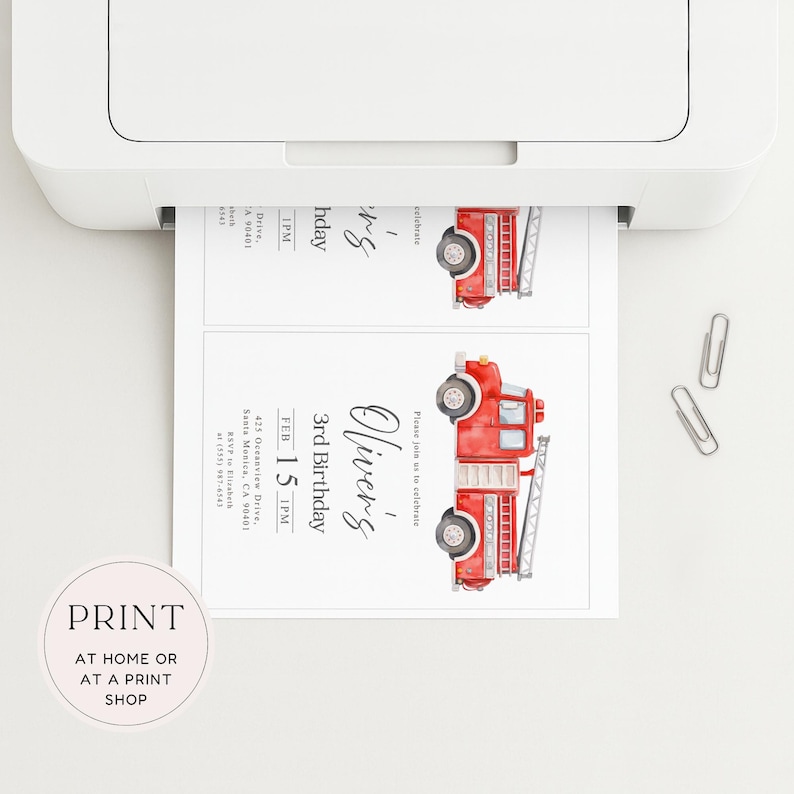 May include: A printer is shown printing two invitations. Each invitation features a watercolor illustration of a red fire truck. The text on the invitation reads "Oliver's 3rd Birthday" and includes the date, time, and location.