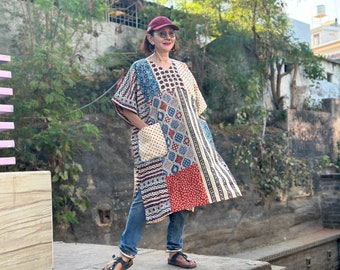 Cotton kaftan dress with an asymmetrical patchwork design. Side slits, a V neckline and pockets. Loose fitting style with a wide sleeve!