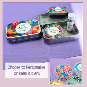 May include: A set of personalized sewing kits in small, rectangular tins. The tins feature colorful patchwork designs and the name "Jennifer." One tin is open, revealing thread and a needle. A small lip balm tube is also included. The text "Choose to Personalize or keep it blank" is visible.