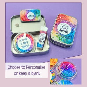 May include: A metal tin set featuring a rainbow-colored dot pattern. The set includes a needle case labeled 'Donna's Needlecase', a small tin labeled 'Donna', a round container labeled 'Donna's Rotary Sharps', and a tube labeled 'I Never Craft Alone, I Have Cats'.