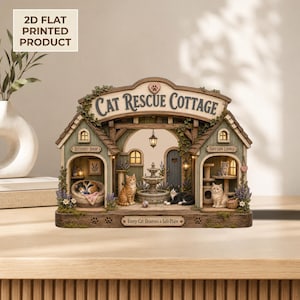 May include: A 2D flat printed decorative display titled Cat Rescue Cottage, featuring a detailed scene of cats in a recovery room and adoption lounge, a central fountain, and the text Every Cat Deserves a Safe Place on the wooden base.