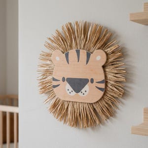 Natural safari nursery wall decor featuring handmade lion and tiger designs with wooden faces and textured fiber details, perfect for boho baby room, neutral nursery styling, and kids room wall art
