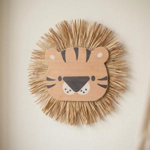 Natural safari nursery wall decor featuring handmade lion and tiger designs with wooden faces and textured fiber details, perfect for boho baby room, neutral nursery styling, and kids room wall art