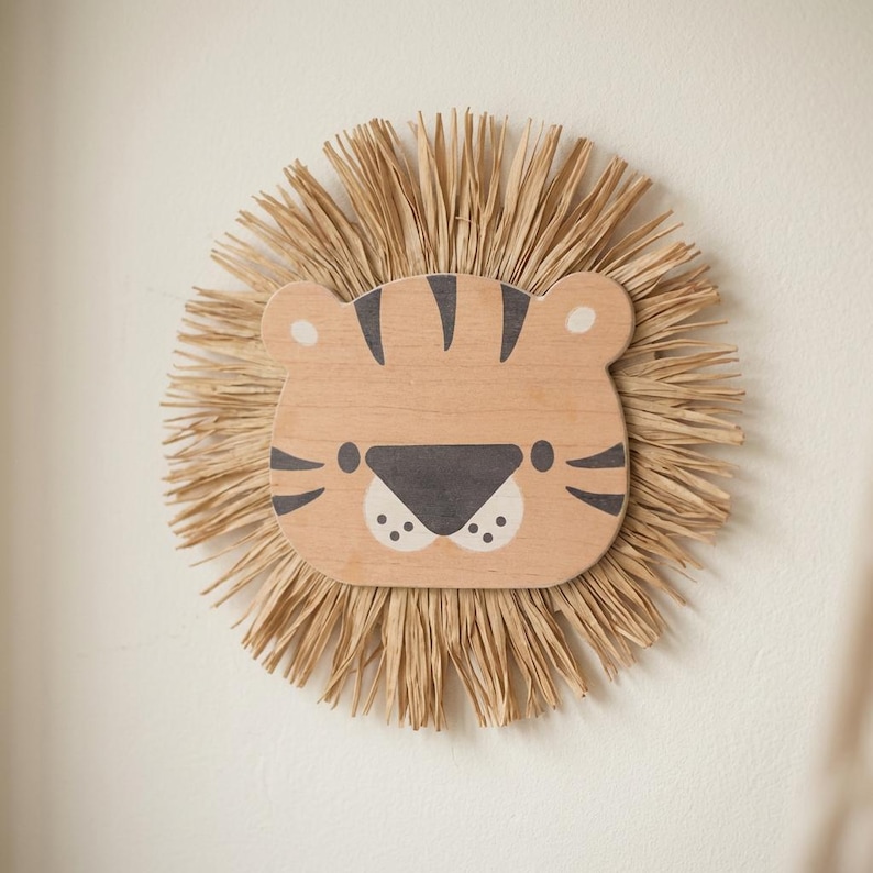 Natural safari nursery wall decor featuring handmade lion and tiger designs with wooden faces and textured fiber details, perfect for boho baby room, neutral nursery styling, and kids room wall art