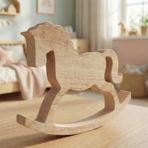 May include: A wooden rocking horse with a natural wood finish. The horse features a traditional design with a curved base, a detailed head, and a flowing mane and tail. The toy is suitable for young children.