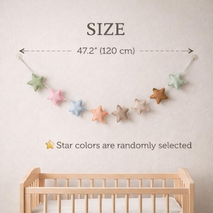 Colorful felt star garland for nursery wall decor with pastel rainbow stars hanging on string, baby room decoration above crib or shelf, soft Montessori nursery decor perfect for kids room and baby shower gift.