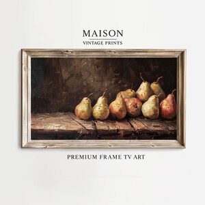 May include: A framed still life painting featuring a collection of pears on a wooden surface. The pears vary in color from green to red, with brown stems. The painting is labeled "MAISON VINTAGE PRINTS" and "PREMIUM FRAME TV ART".