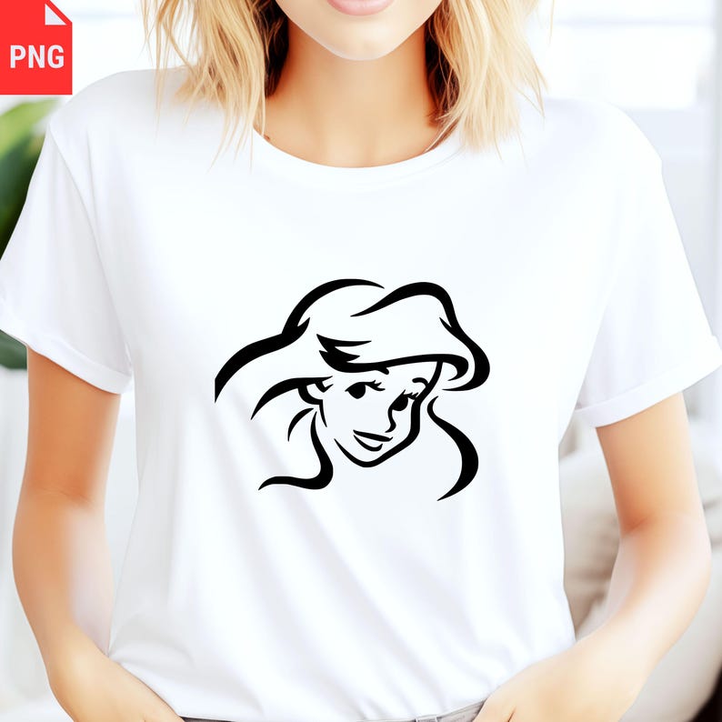 May include: White t-shirt featuring a black line drawing of a cartoon character's face. The character has long flowing hair and a smiling expression. The shirt is made of a soft material and has short sleeves.