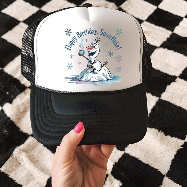 May include: A black and white trucker hat with a white front panel featuring a cartoon snowman holding a mug. The text "Happy Birthday, Snowflake!" is printed above the snowman, with snowflake graphics.