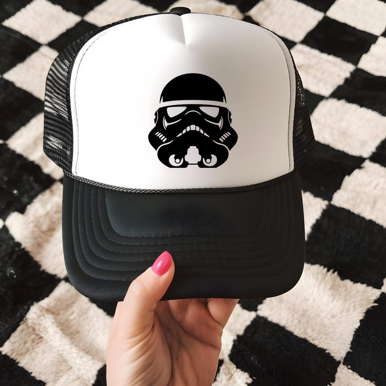 May include: Black and white trucker hat featuring a Stormtrooper helmet design. The hat has a black brim and mesh back, with a white front panel displaying the helmet graphic. A stylish accessory for fans of the iconic sci-fi franchise.