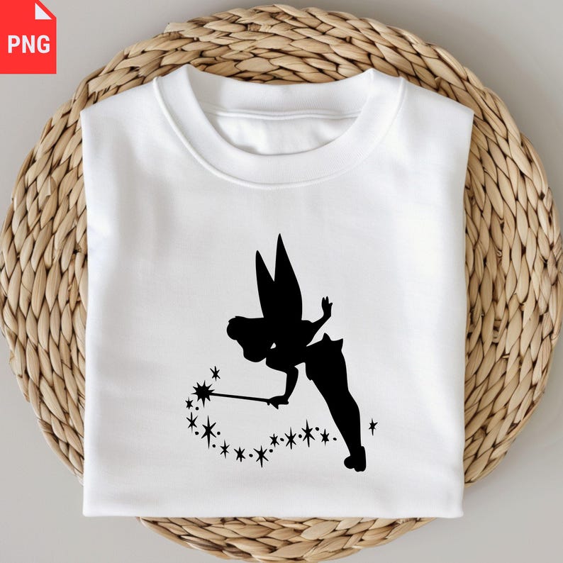 May include: White sweatshirt featuring a black silhouette of a fairy with a wand and stars. The fairy is depicted with large wings and a flowing dress. The design is centered on the front of the shirt, creating a whimsical and magical aesthetic.