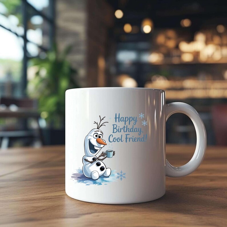 May include: White ceramic mug featuring a cartoon image of Olaf from Frozen, holding a small cup. The mug has the text "Happy Birthday, Cool Friend!" in light blue. The mug has a large, rounded handle and is sitting on a wooden surface.
