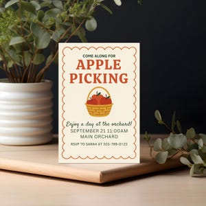 May include: An invitation card with a scalloped border, featuring the text "Come Along For Apple Picking" in brown. A basket of red apples is illustrated below the text. Additional text includes date, time, location, and RSVP information.