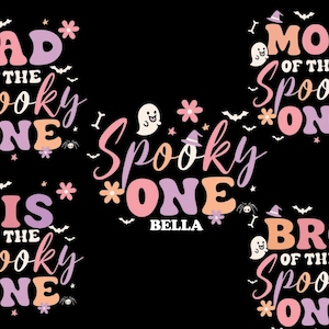 May include: A black graphic design featuring the words "DAD of the Spooky ONE", "MOM of the Spooky ONE", "SIS of the Spooky ONE", "BRO of the Spooky ONE", and "Spooky ONE BELLA" in a retro font. The design includes ghosts, bats, and flowers.