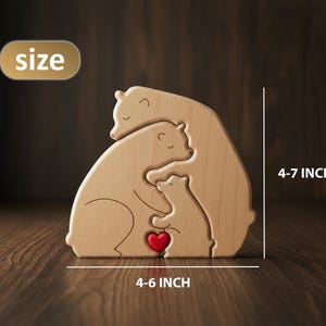 May include: Wooden bear family sculpture with a red heart, measuring 4-6 inches wide and 4-7 inches tall. The bears are light brown and interlock, creating a family-themed decorative piece.