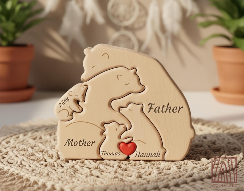 May include: A wooden bear family puzzle with the words "Father", "Mother", and children's names engraved. A red heart is placed between the two smaller bears. The puzzle is made of light-colored wood and is designed to interlock.