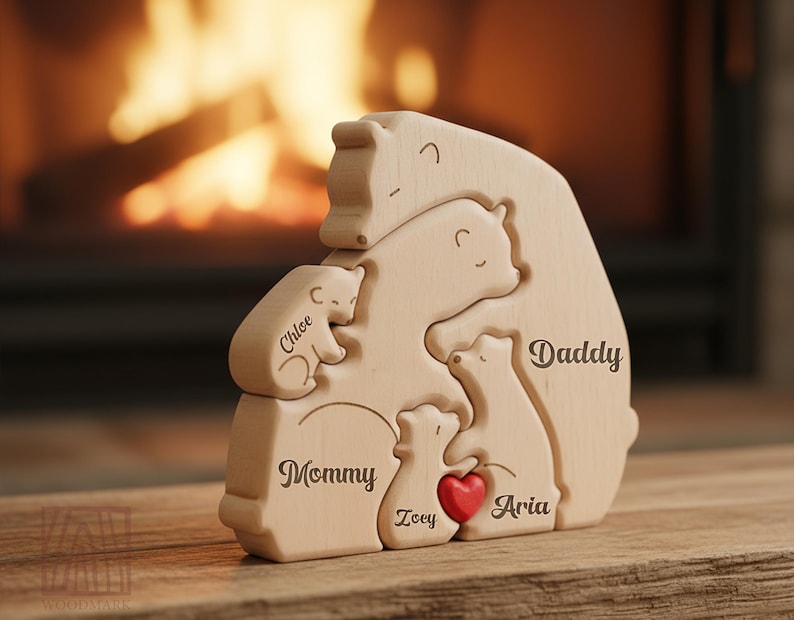 May include: A wooden puzzle featuring a family of bears, with each bear representing a family member. The names "Chloe", "Mommy", "Zoey", "Aria", and "Daddy" are engraved on the bears. A small red heart is included.