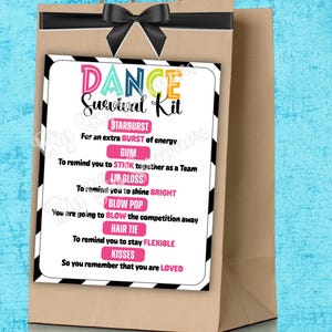 May include: A brown paper gift bag with a black bow and a white card. The card has a black and white striped border and the words "DANCE Survival Kit" in colorful letters. The card lists items like Starburst, gum, lip gloss, and hair tie.