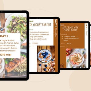May include: A digital tablet displays a meal plan with images of Greek yogurt parfait, apple slices with peanut butter, grilled chicken salad, and baked salmon. The text reads "Day 1" and lists the meals with calorie information.