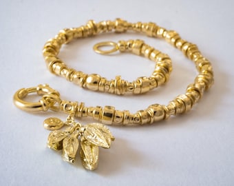 18k solid gold beaded bracelet with cluster of 18k solid gold seeds, handmade, resizable, fine jewelry.