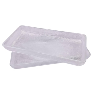 May include: Two clear glass serving trays with a textured surface. The trays are stacked on top of each other.